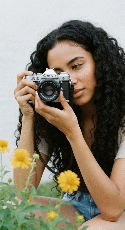 Person creating a vision board for their portfolio website, with images of design layouts, project ideas, and career goals